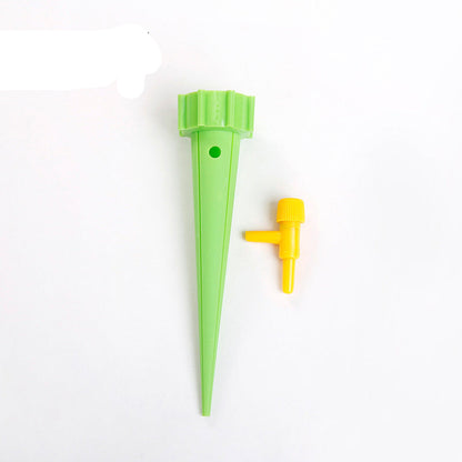Green plastic plant waterer with yellow valve on a white background, labeled '12PCS'.