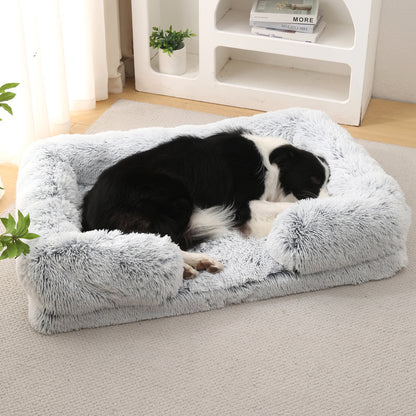 Dog resting on a fluffy gray pet bed in a home setting.