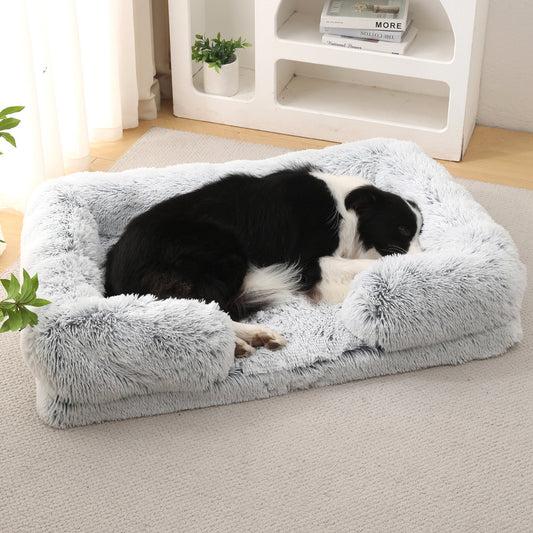 Dog resting on a fluffy gray pet bed in a home setting.