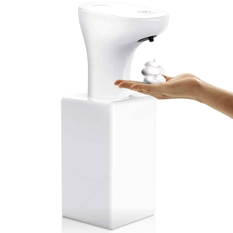 Hand pressing a white soap dispenser on a white background