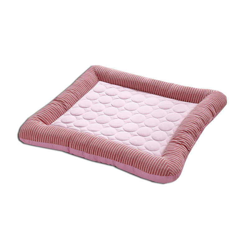 Pink pet bed with quilted design on a white background