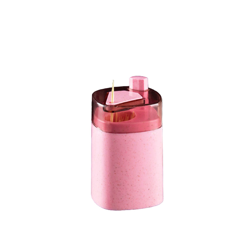 Pink toothpick holder with measurements on a gray surface with coffee beans and a white container.