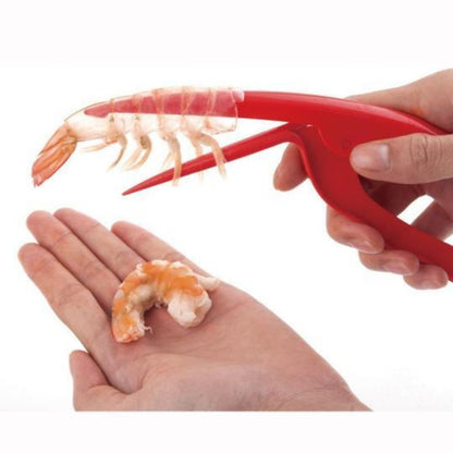 Red shrimp peeler tool being used to remove shrimp from a shell.