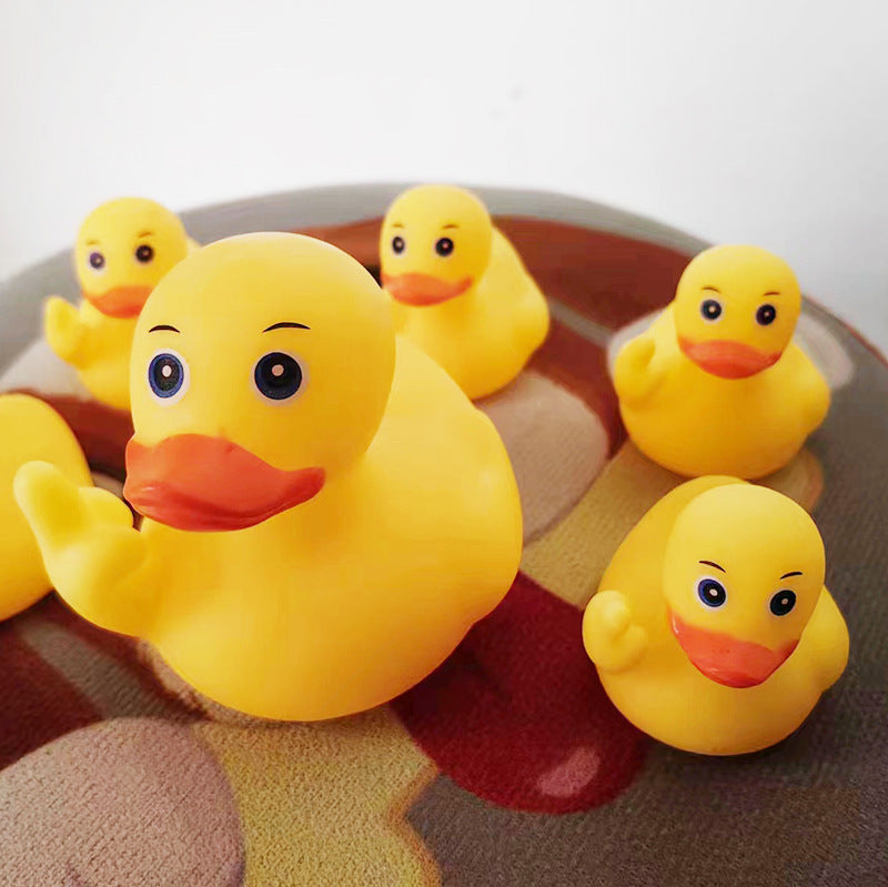 Yellow rubber duck toys on a checkered fabric background