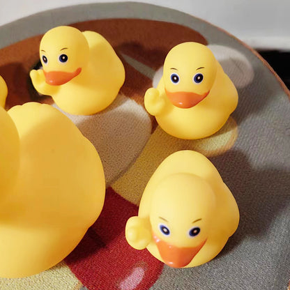 Four yellow rubber ducks on a checkered fabric background
