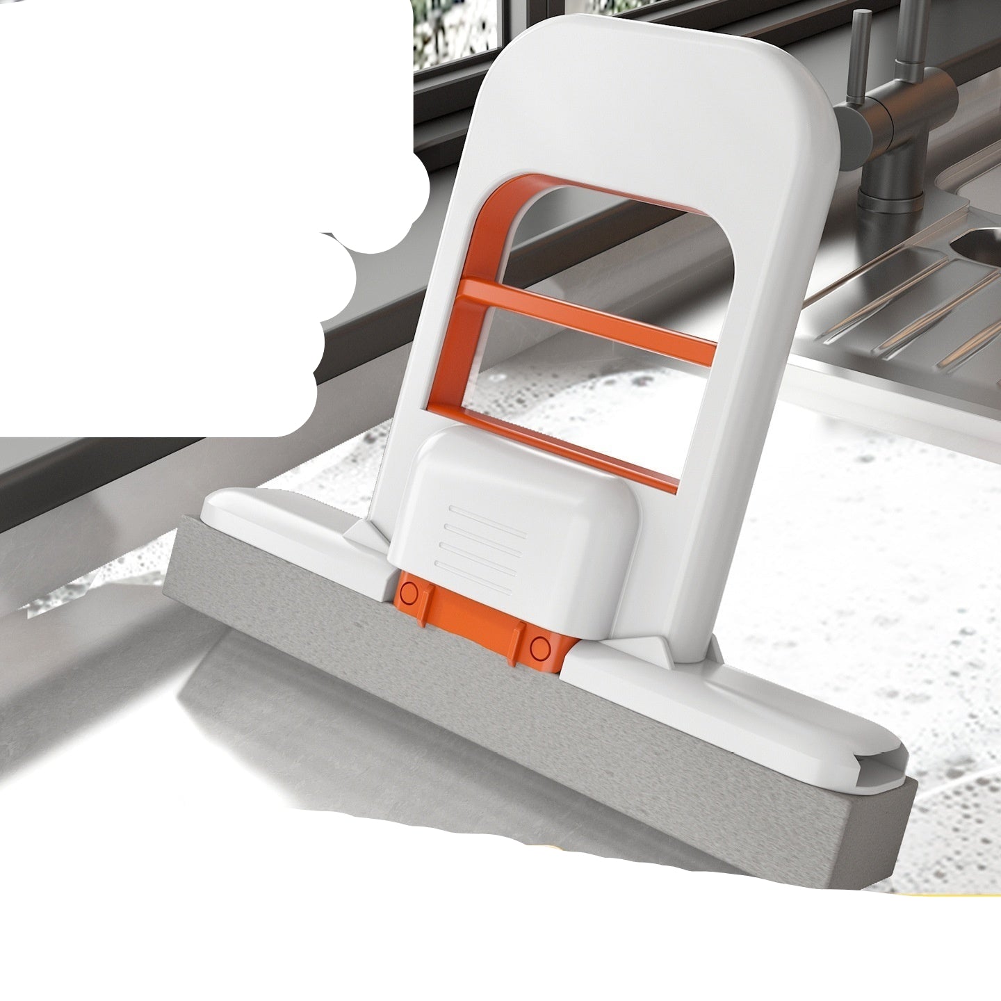 Cleaning tool with white and orange design on a kitchen counter.