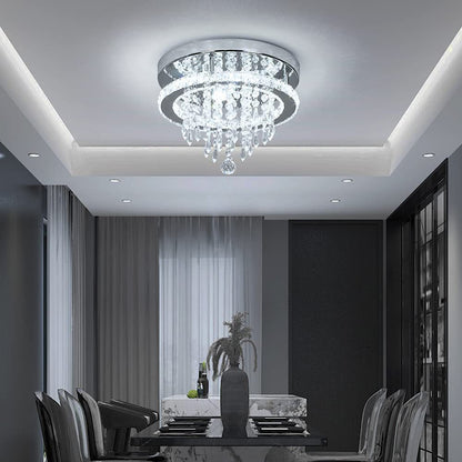 Modern chandelier in a dining room setting with a table and chairs.