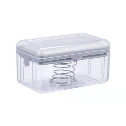 Clear plastic container with a spring inside on a white background