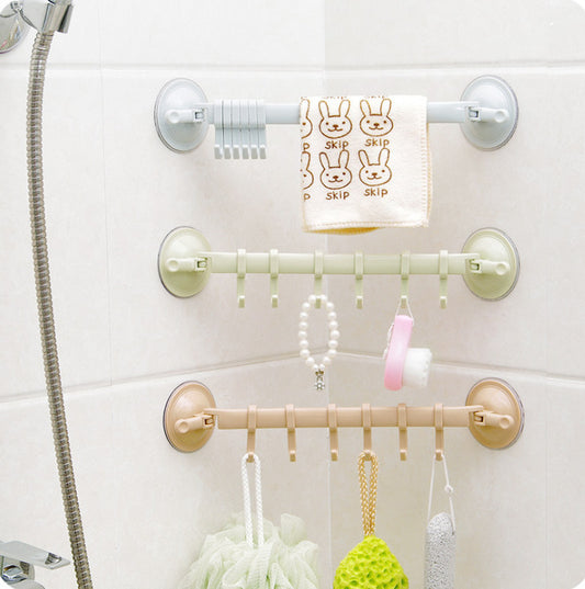 Wall-mounted shower caddy with multiple hooks holding various items on a white tiled wall.