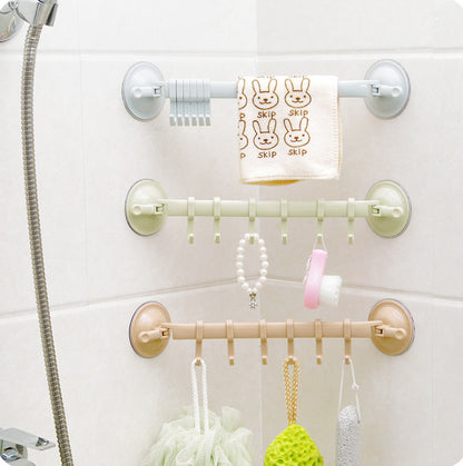 Wall-mounted shower caddy with multiple hooks holding various items on a white tiled wall.
