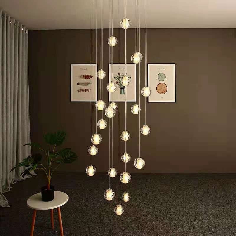 Modern chandelier hanging in a room with framed pictures on the wall.