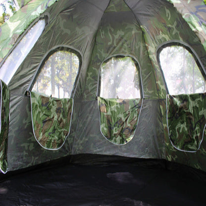 Camouflage-patterned tent interior with windows showing a natural outdoor setting.