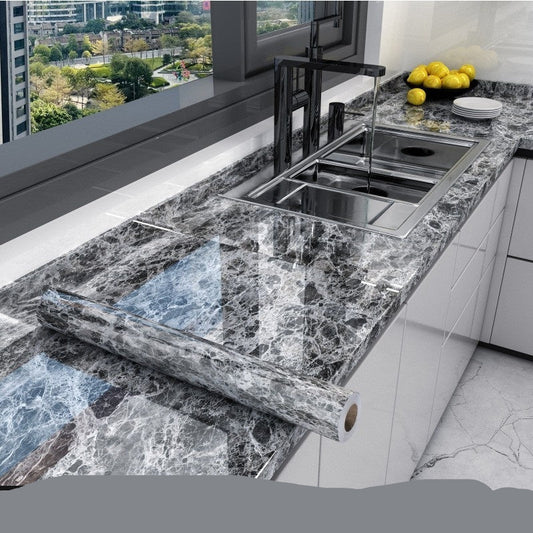 Marble-patterned kitchen countertop with sink and window view