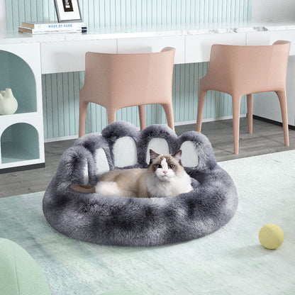 Cat lying on a paw-shaped pet bed in a room with chairs and a shelf.