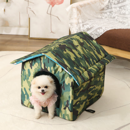 Camouflage pet house with a small white dog inside on a light-colored floor.