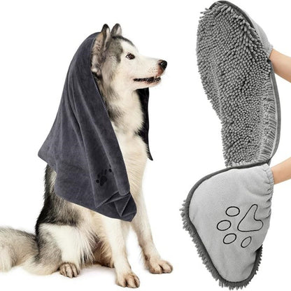 Dog wearing a towel with a paw-shaped cleaning tool held above it