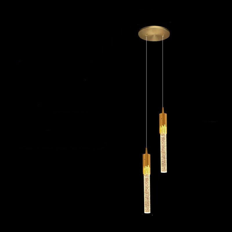 Gold pendant light with measurements on a black background