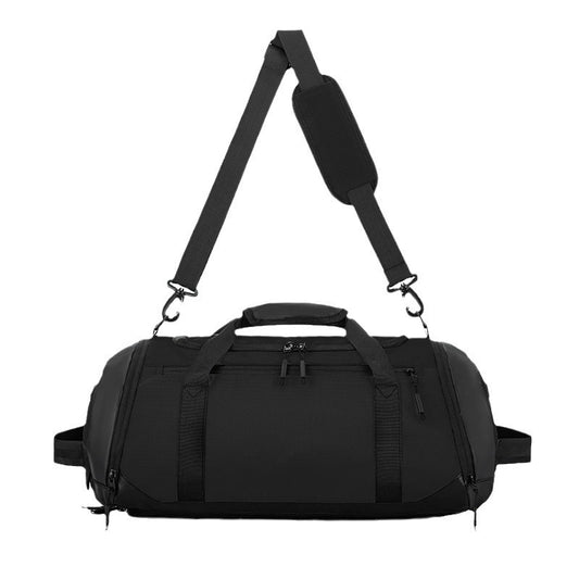Black duffel bag with a shoulder strap on a white background