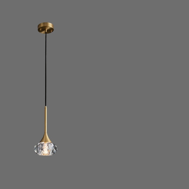 Gold pendant light with adjustable suspension wire on a gray background