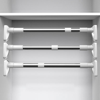 Set of three extendable curtain rods in a white cabinet.