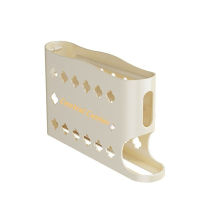 Beige magazine holder with cut-out design on a white background