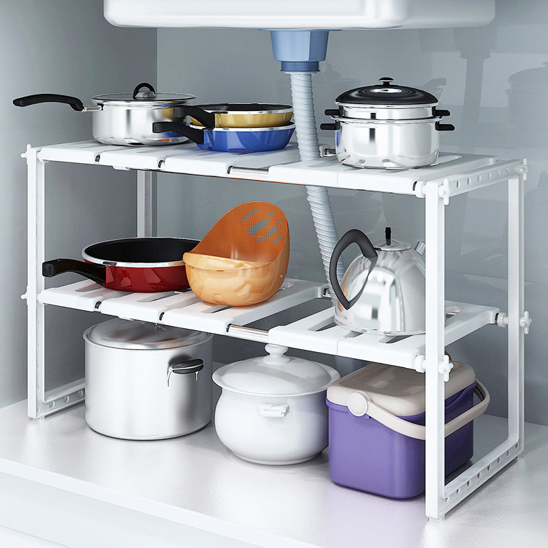 White metal shelf with kitchen utensils including pots, pans, and bowls under a kitchen sink.