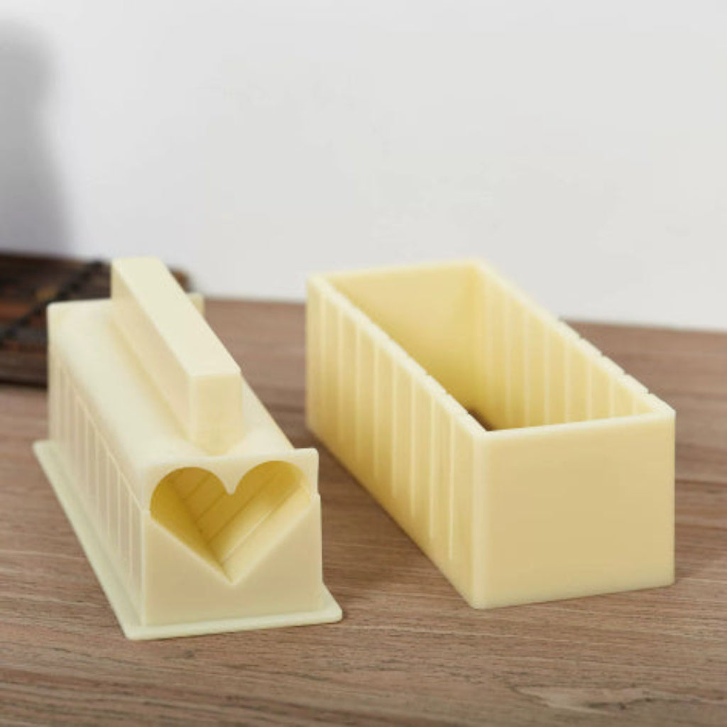 Two rectangular cheese cutters with a heart-shaped indentation on a wooden surface.