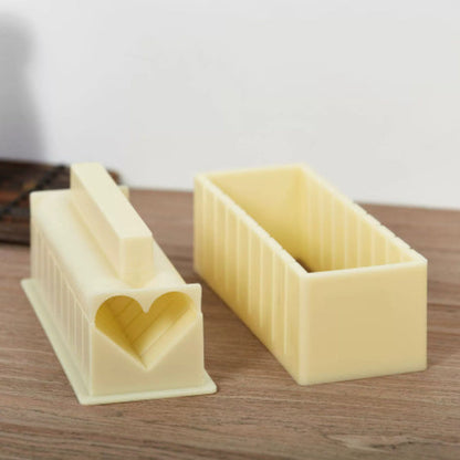 Two rectangular cheese cutters with a heart-shaped indentation on a wooden surface.
