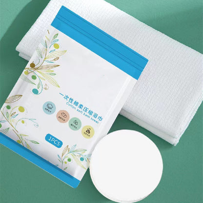 Cotton bath towel with packaging on a green background