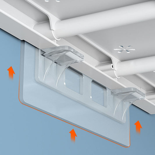 Clear plastic panel attached to a ceiling with orange arrows indicating installation directions.