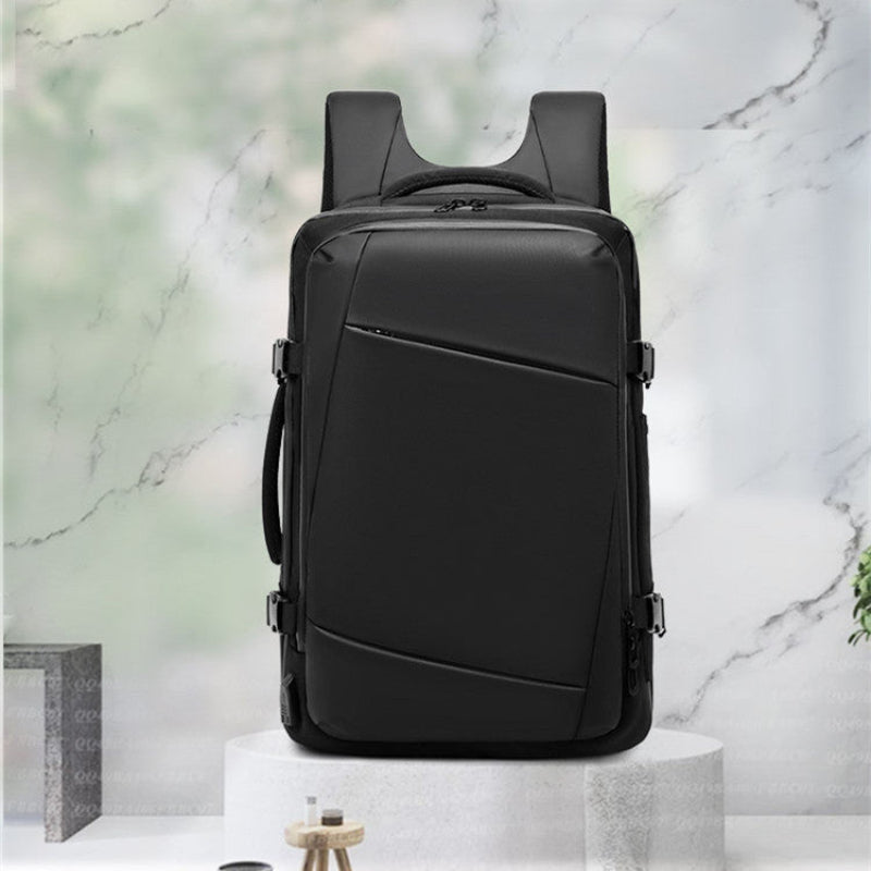 Black backpack on a white pedestal with a marble background