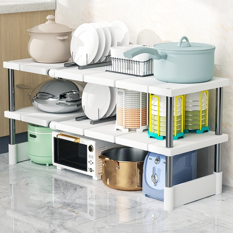 Multi-layer kitchen storage rack with utensils and appliances on a tiled floor.