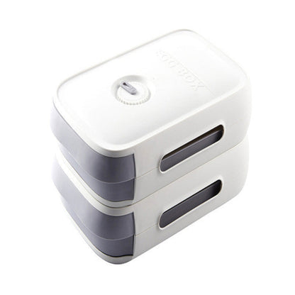 White and gray rectangular device with a circular component on a white background