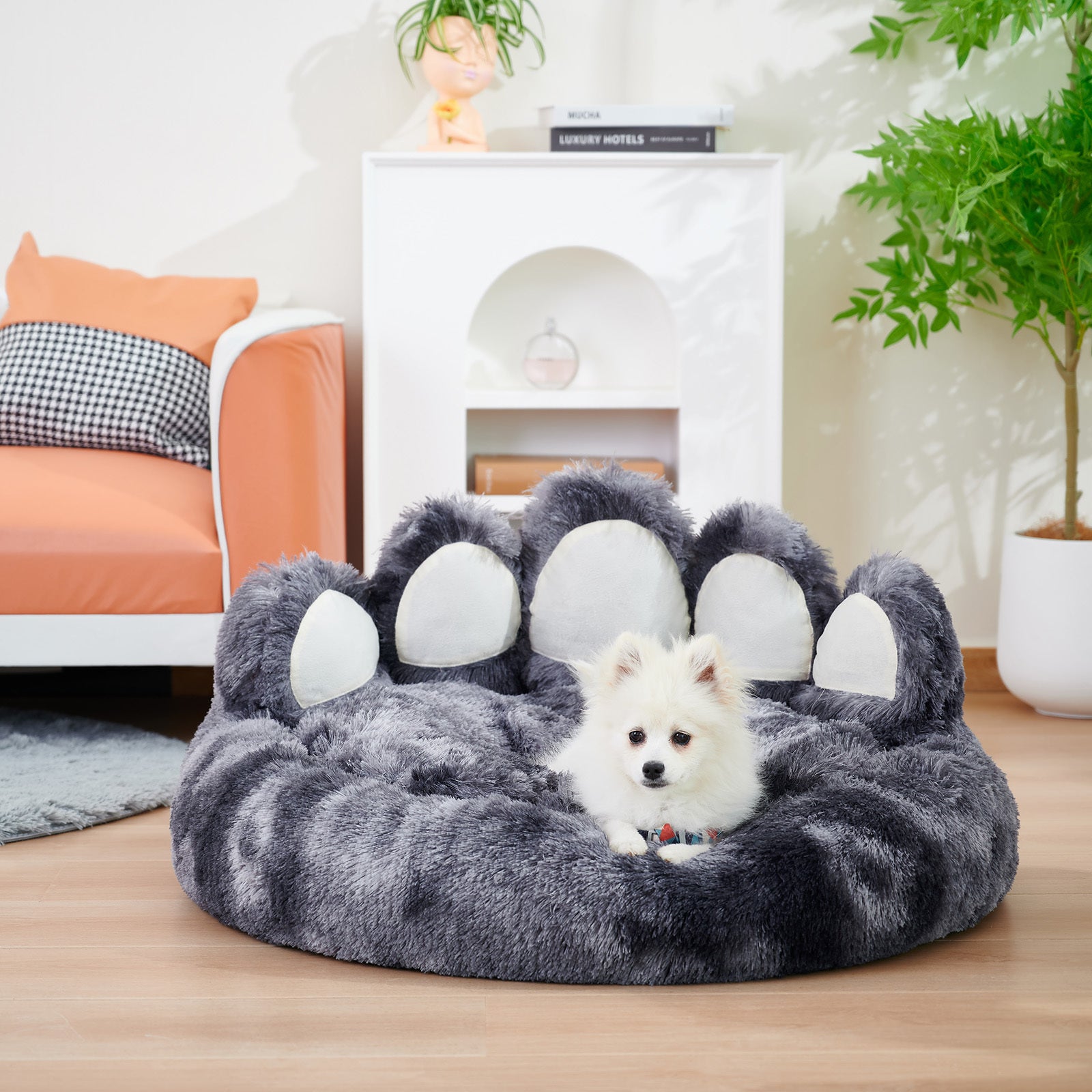 Dog lying on a paw-shaped pet bed in a cozy living room.