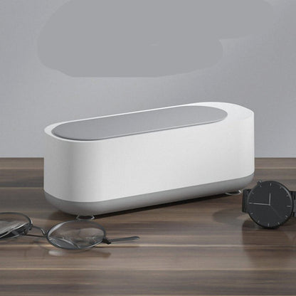 White electronic device on a wooden surface with text describing its features