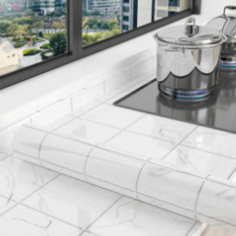 Modern kitchen with tiled floor and large windows