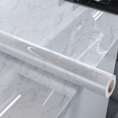 Roll of clear plastic sheeting on a marble surface