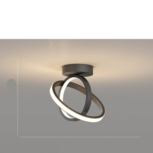 Modern ceiling light fixture with circular design on a neutral background