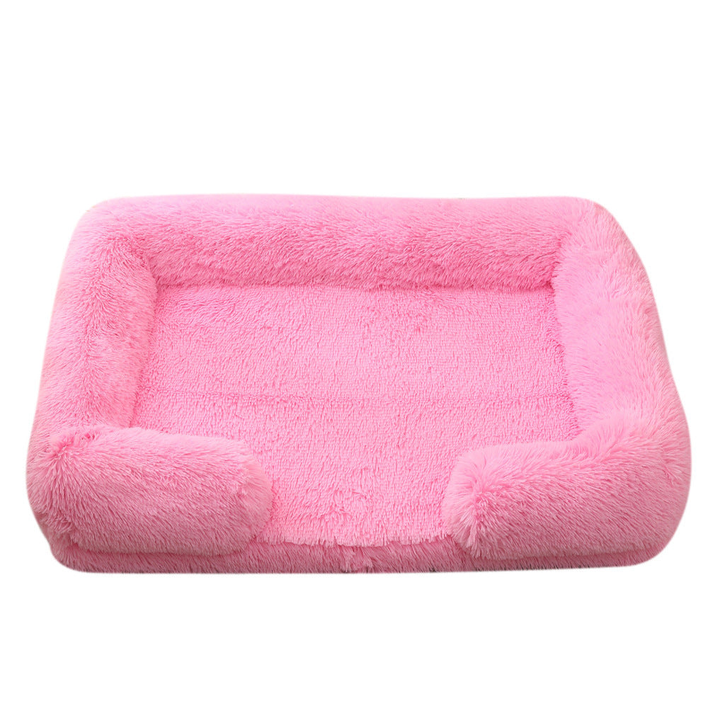 Pink fluffy pet bed on a white background