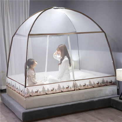 Children playing inside a transparent bed canopy with a deer pattern on a bed.