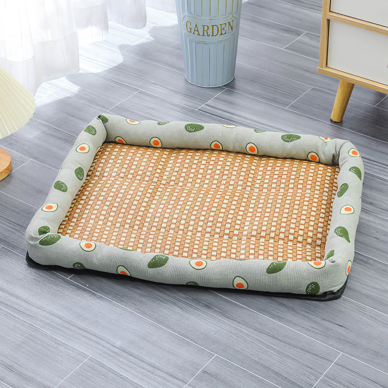 Woven pet bed with green and orange pattern on a gray floor