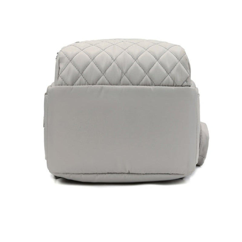 Gray quilted ottoman on a white background