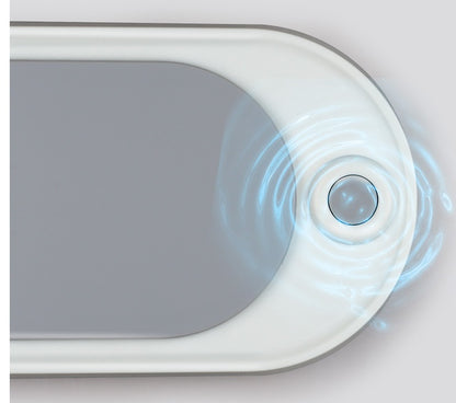 Close-up of a white electronic device with a circular sensor on a light gray background