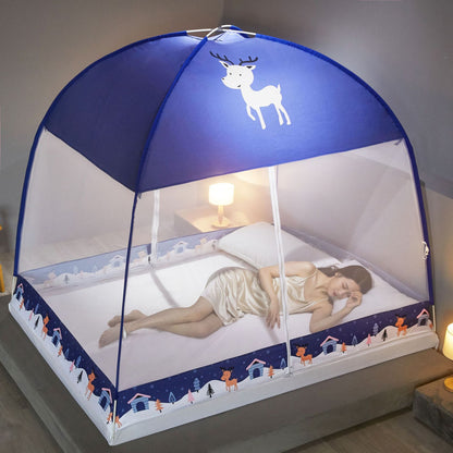 Child's bed with a blue canopy featuring a deer design, lit by a lamp in a cozy room.