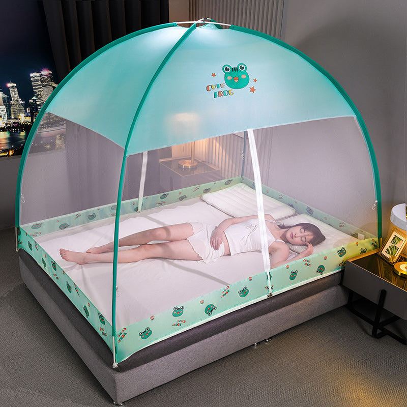 Child lying in a green children's bed with a mosquito net in a bedroom setting.