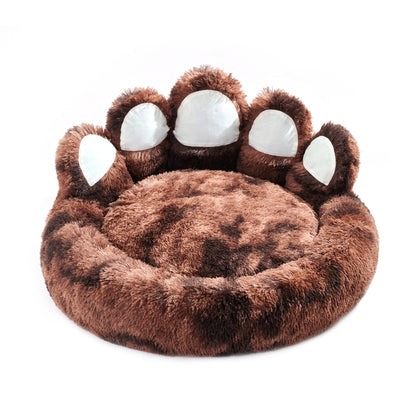 Brown paw-shaped pet bed with white pads on a white background