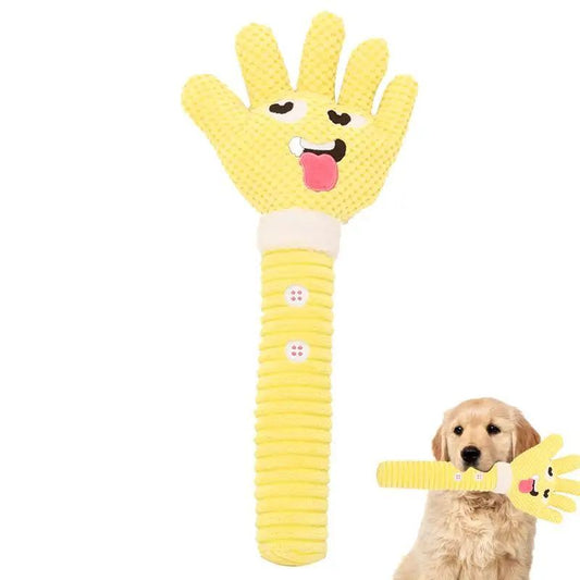 Yellow dog toy shaped like a hand with a dog holding it on a white background