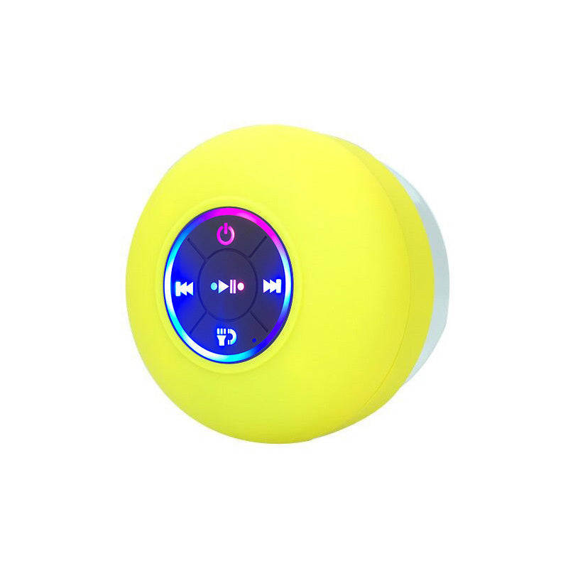 Yellow spherical Bluetooth speaker with control buttons on a white background