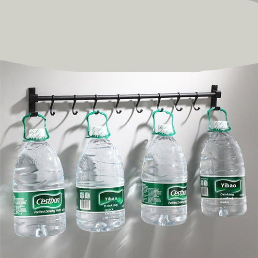Four water bottles hanging from a metal rod with text about load-bearing capacity.