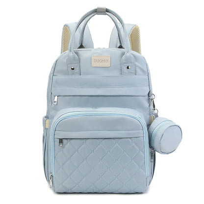 Light blue backpack with quilted design and baby bottle holder on a white background